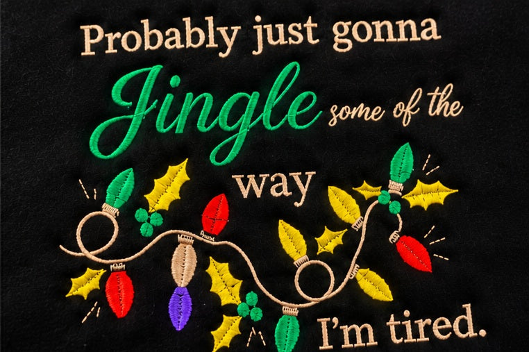 Jingle holiday embroidery detail on black hoodie