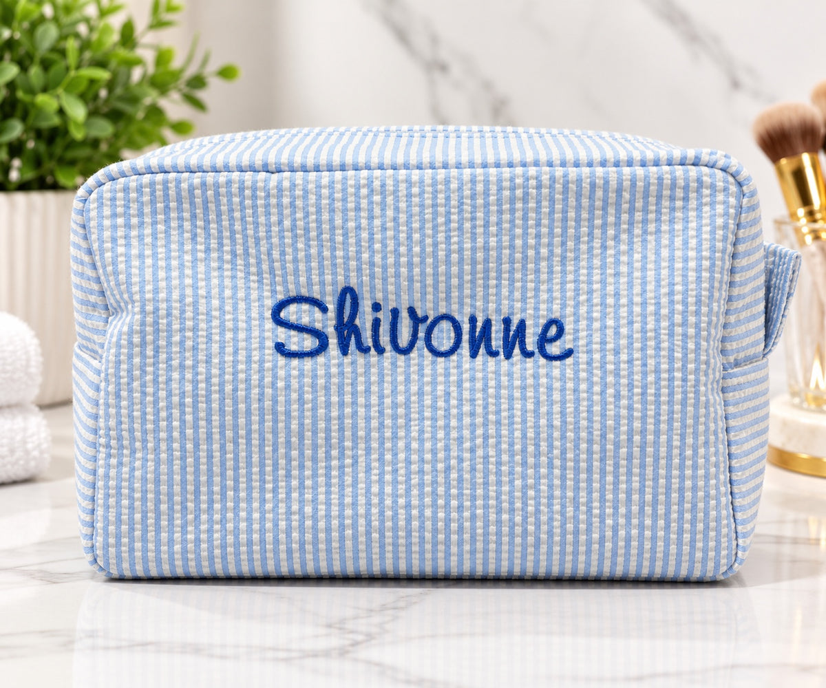 Personalized blue and white striped cosmetic bag with embroidered name