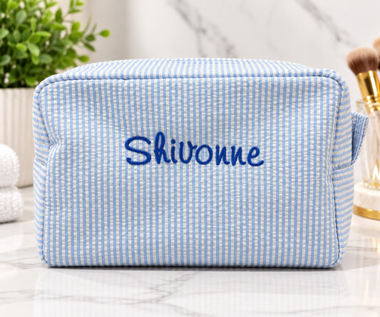 Personalized blue and white striped cosmetic bag with embroidered name